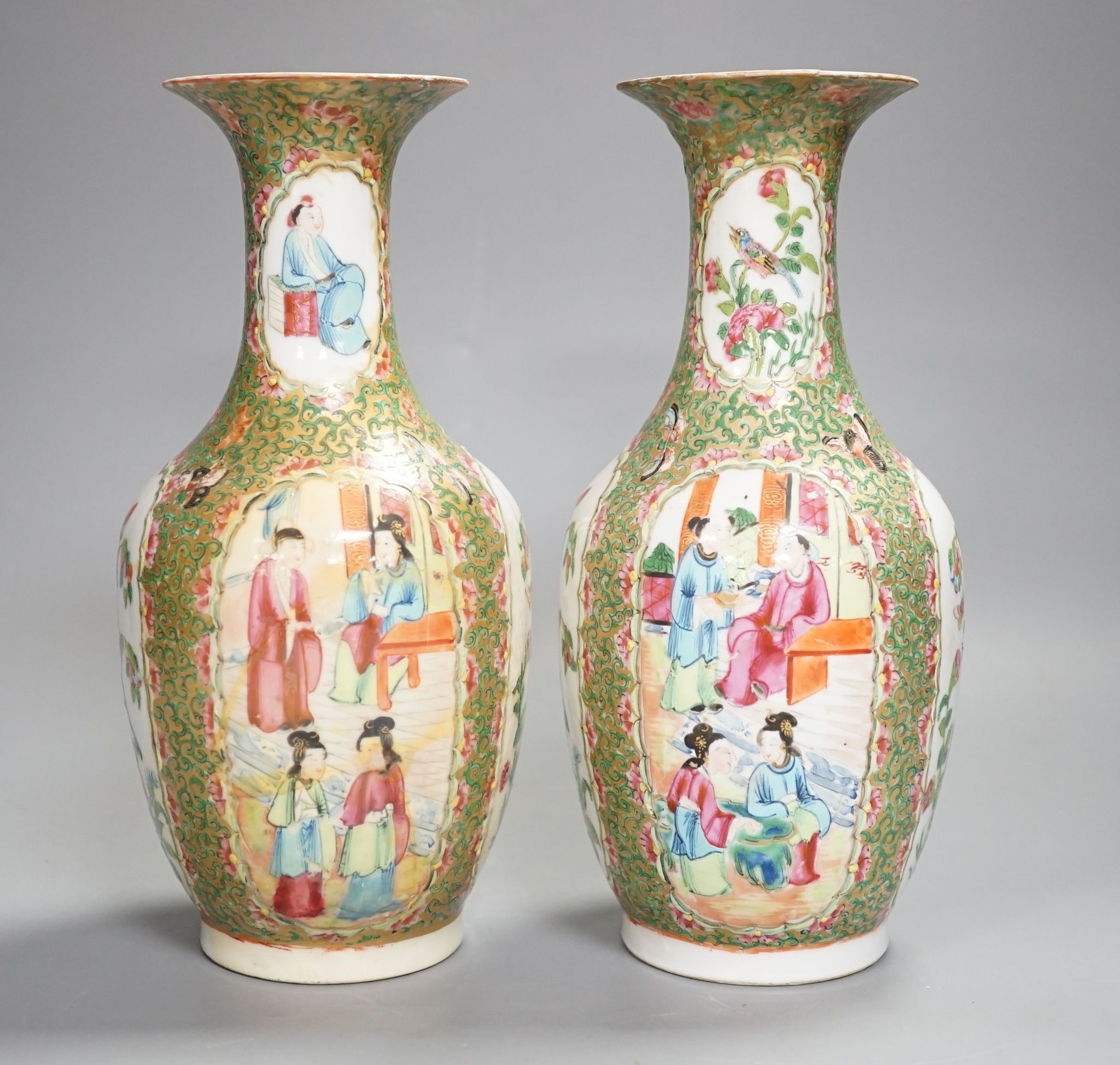 A pair of 19th century Chinese famille rose vases, 24 cms high.